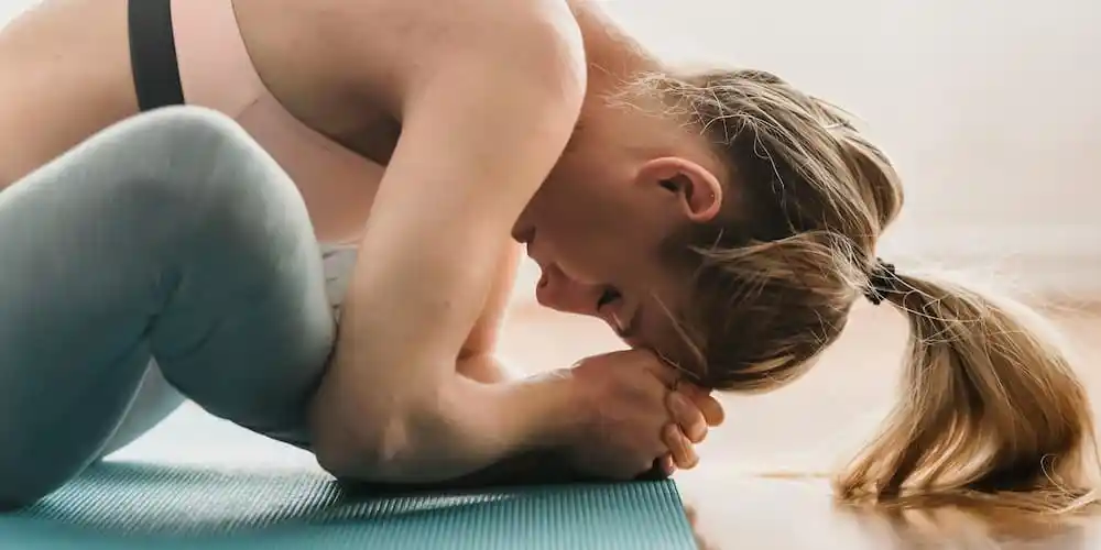 A woman stretches her back